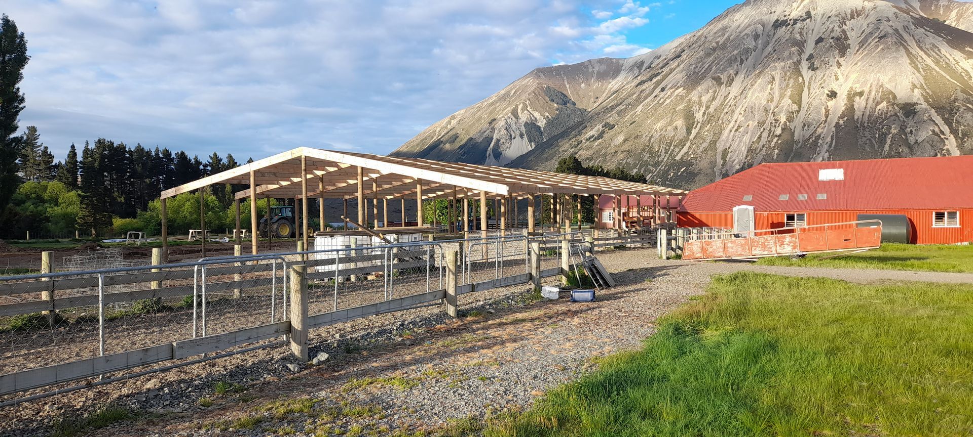 A large red building with a mountain in the background is being built.