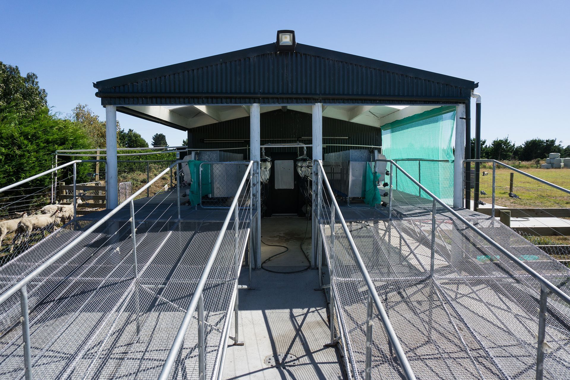 A metal ramp leading to a building with a roof.
