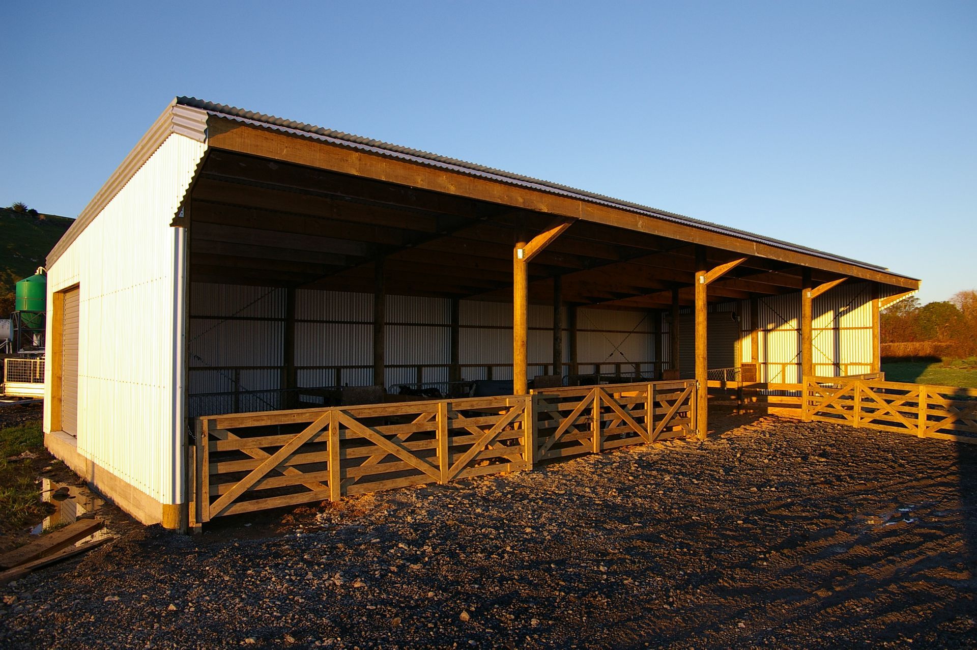 A white building with a wooden fence around it