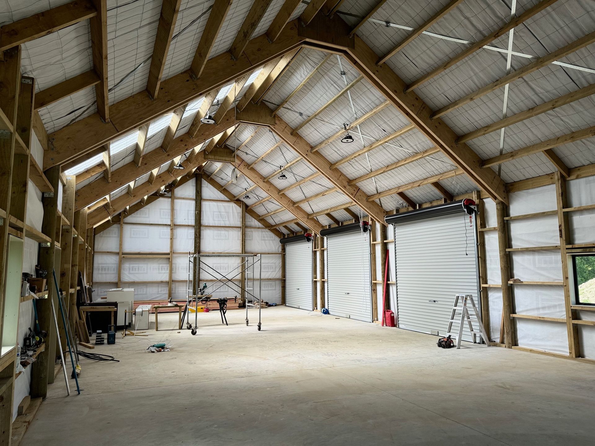 A large empty building with a wooden roof and a white door.