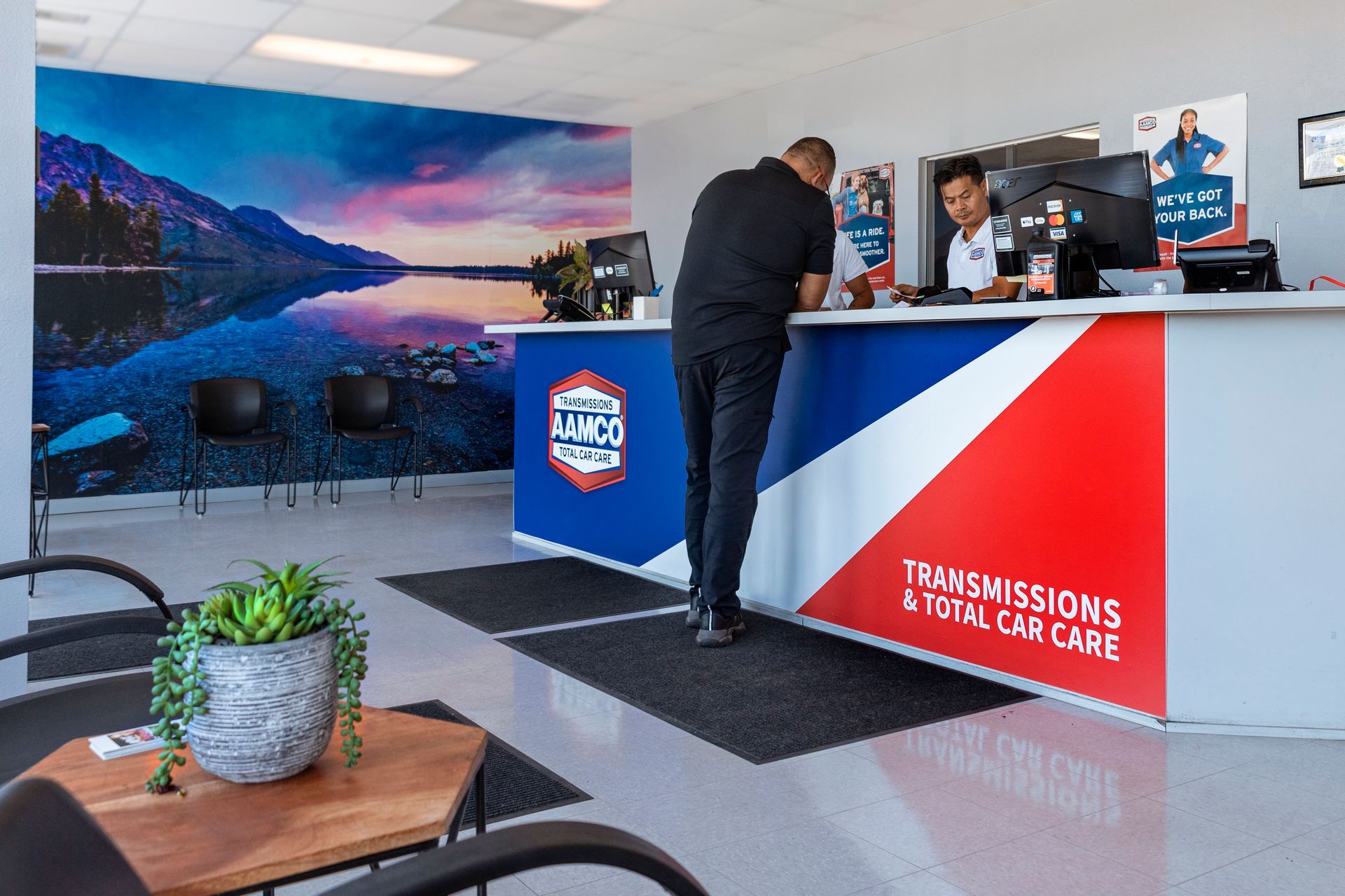 Customer at service counter inside an AAMCO Center in Port Richey, FL.