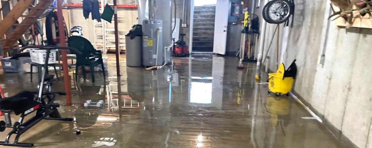 A flooded basement with a lot of water on the floor.