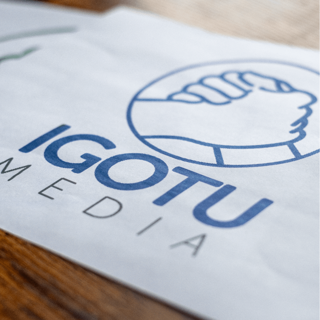 Logo for IGOTU Media, blue text on a white background with handshake icon in a blue circle.