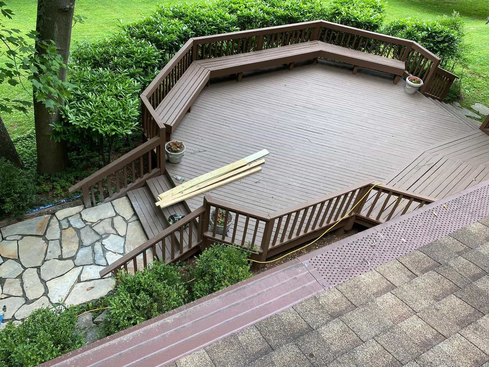 An aerial view of a wooden deck with stairs and a bench.
