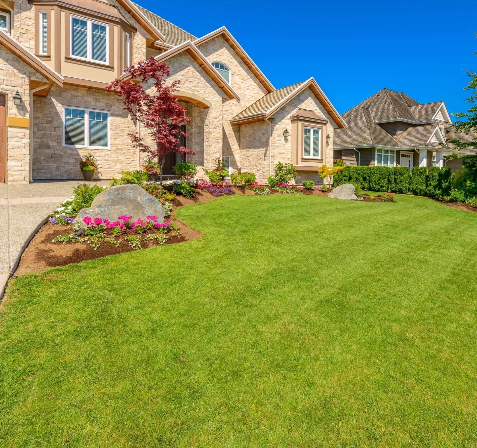 A large house with a lush green lawn in front of it