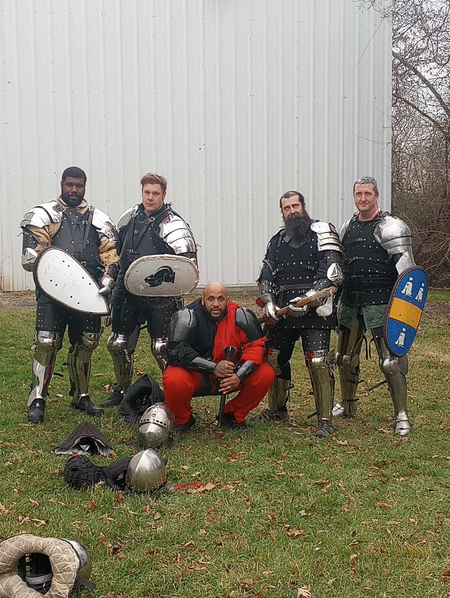 A Group of Men in Armor Are Posing - DE - Diamond State Steel Academy