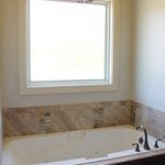 Gorgeous Bathtub in Front of a Large Window, Created by Watts Construction in Mid-MO