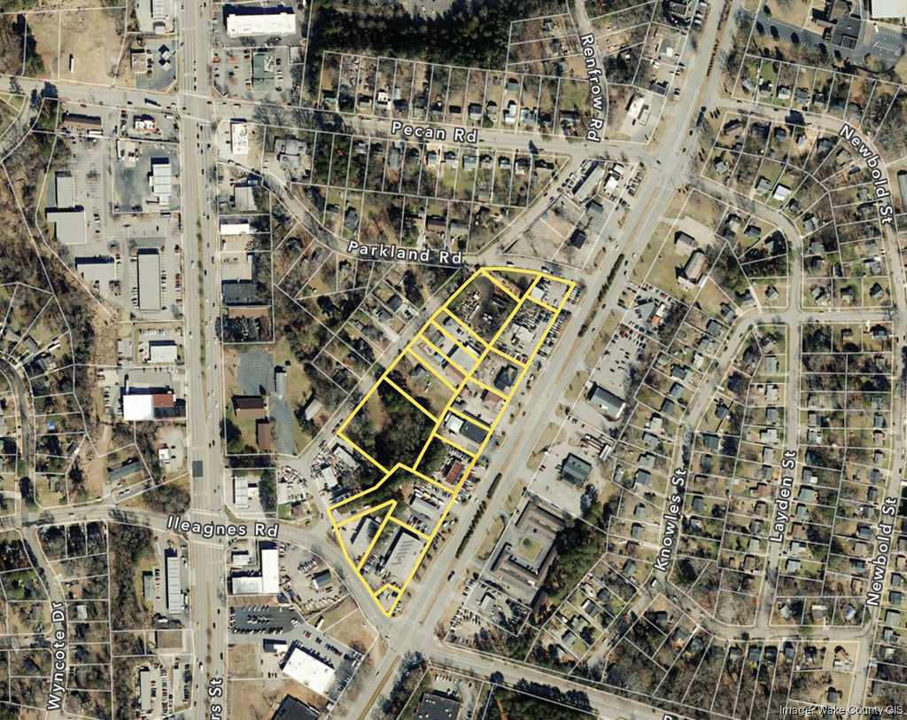 Overhead aerial view of a town, highlighting a block of buildings with yellow outlines.