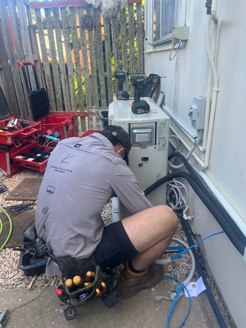 A Man Is Working On A Residential Site Organising Cable  — Kilowatts & Cool Whitsundays In Strathdickie, QLD
