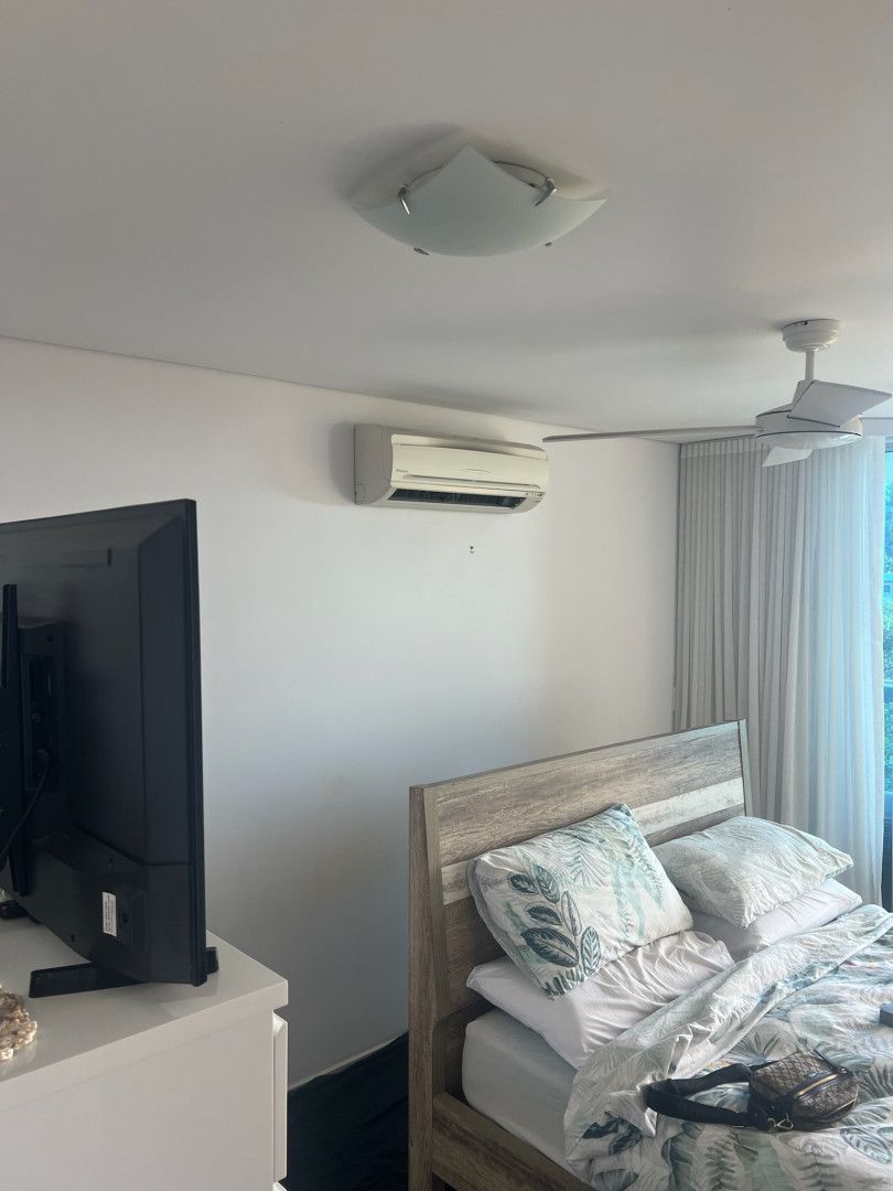 A Bedroom With an Air Conditioning Unit On The Wall And A Bed To The Left— Kilowatts & Cool Whitsundays In Strathdickie, QLD