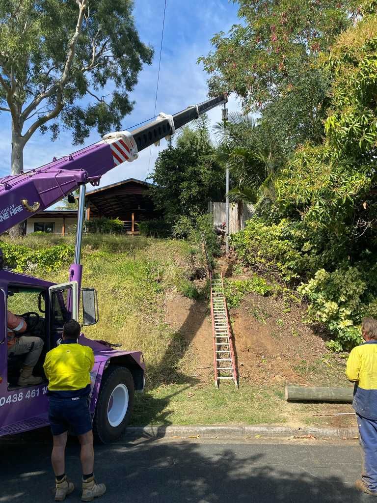 A Truck With a Crane Attached to It is Parked on the Side of the Road — Kilowatts & Cool Whitsundays In Proserpine, QLD