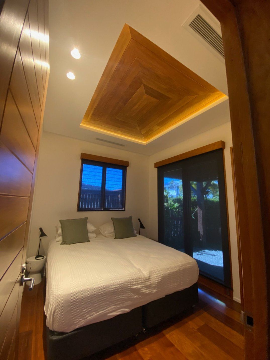 A Bedroom With a Large Bed and a Wooden Ceiling — Kilowatts & Cool Whitsundays In Strathdickie, QLD