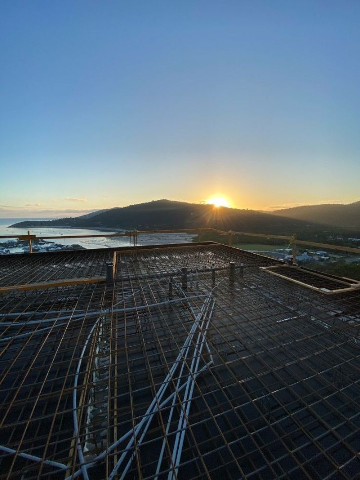 The Sun is Setting From the Top of a Building Under Construction — Kilowatts & Cool Whitsundays In Strathdickie, QLD