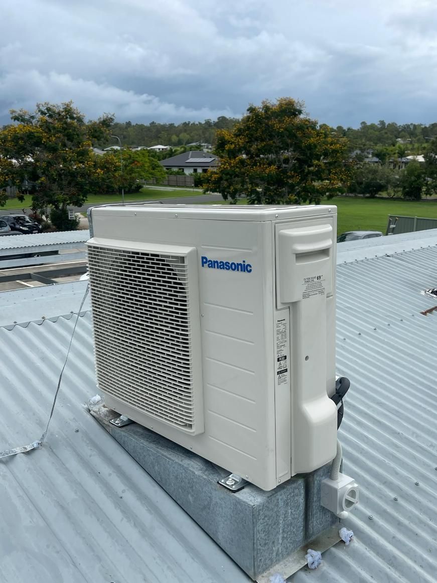 A Panasonic Air Conditioner Is Sitting on Top of A Metal Roof — Kilowatts & Cool Whitsundays In Airlie Beach, QLD