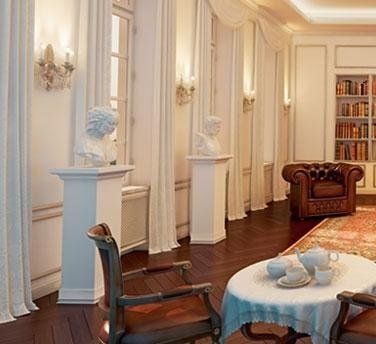 Salone decorato con statue di gesso con piedistallo e stucchi