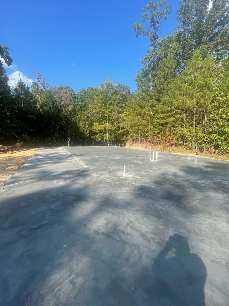 A parking lot with trees on the side of it and a blue sky in the background.