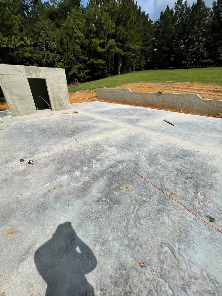 A shadow of a person is cast on a concrete surface