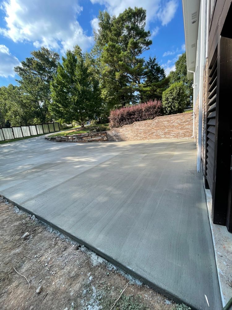 A concrete driveway is being built in front of a house.