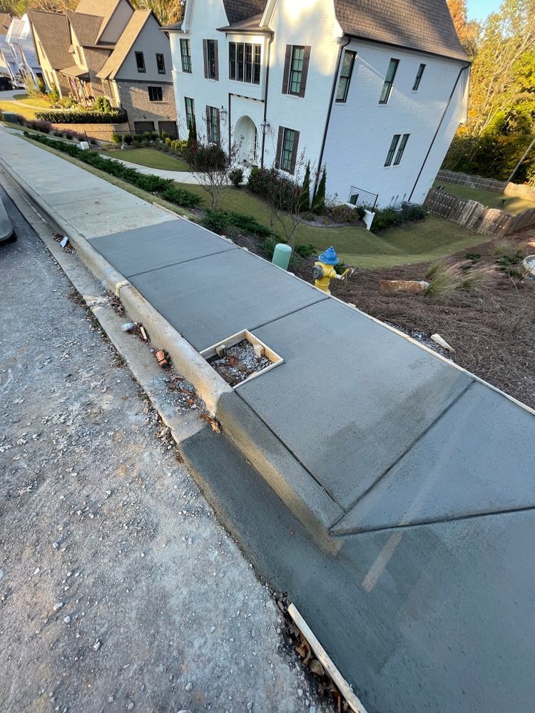 A concrete walkway is being built in front of a house.