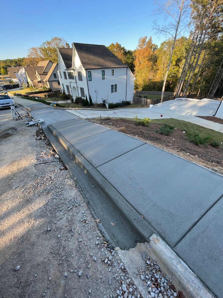 A concrete sidewalk is being built in front of a house.