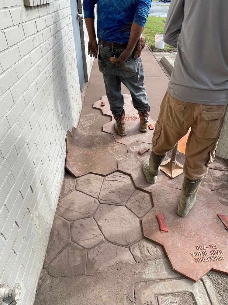 A couple of men standing next to each other on a sidewalk.