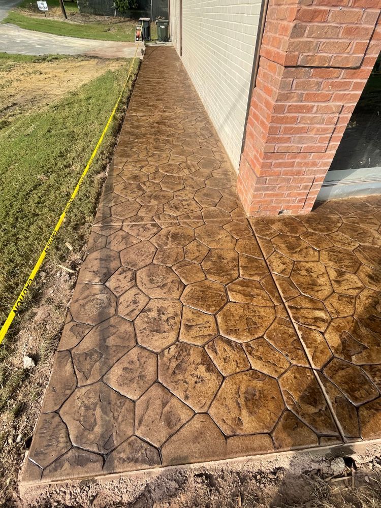 A concrete walkway is being built next to a brick building.