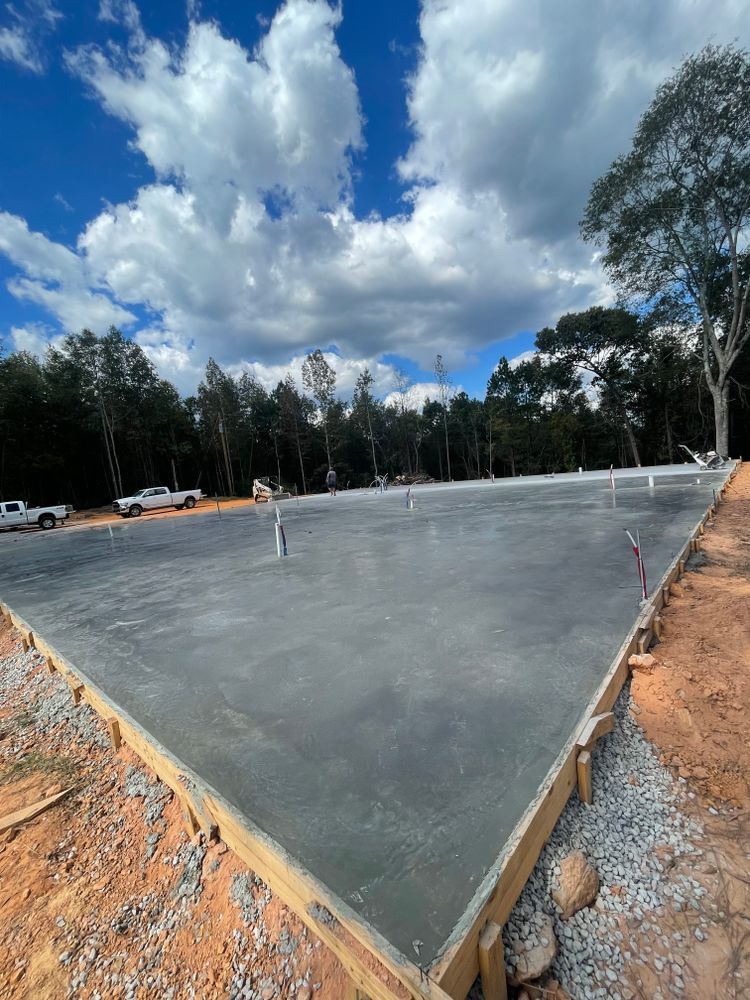 A large concrete slab is being built in a parking lot.