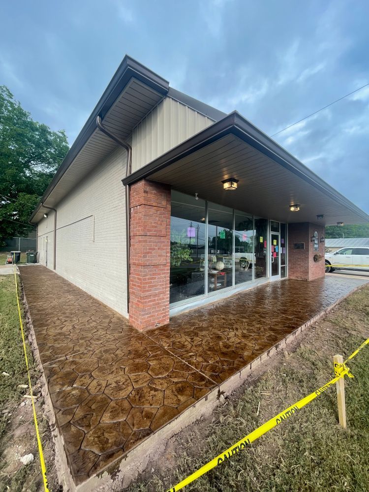A large building with a concrete walkway in front of it.