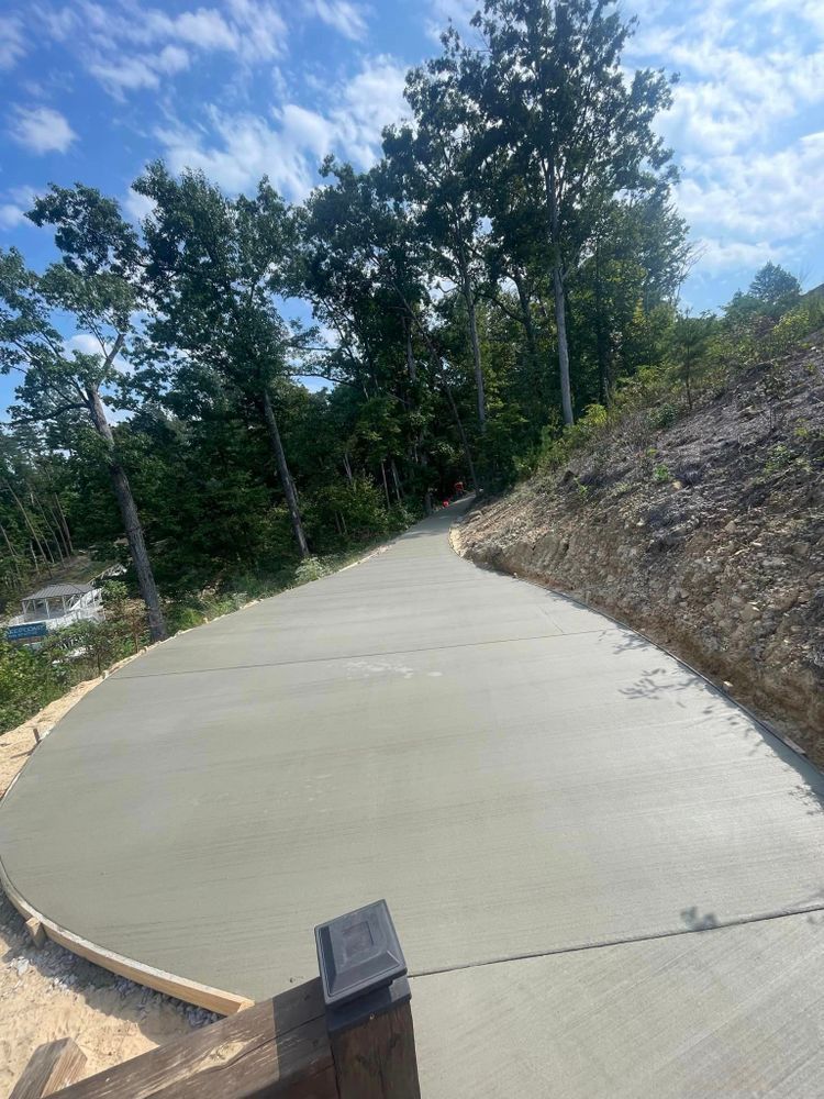 A concrete driveway is being built in the middle of a forest.