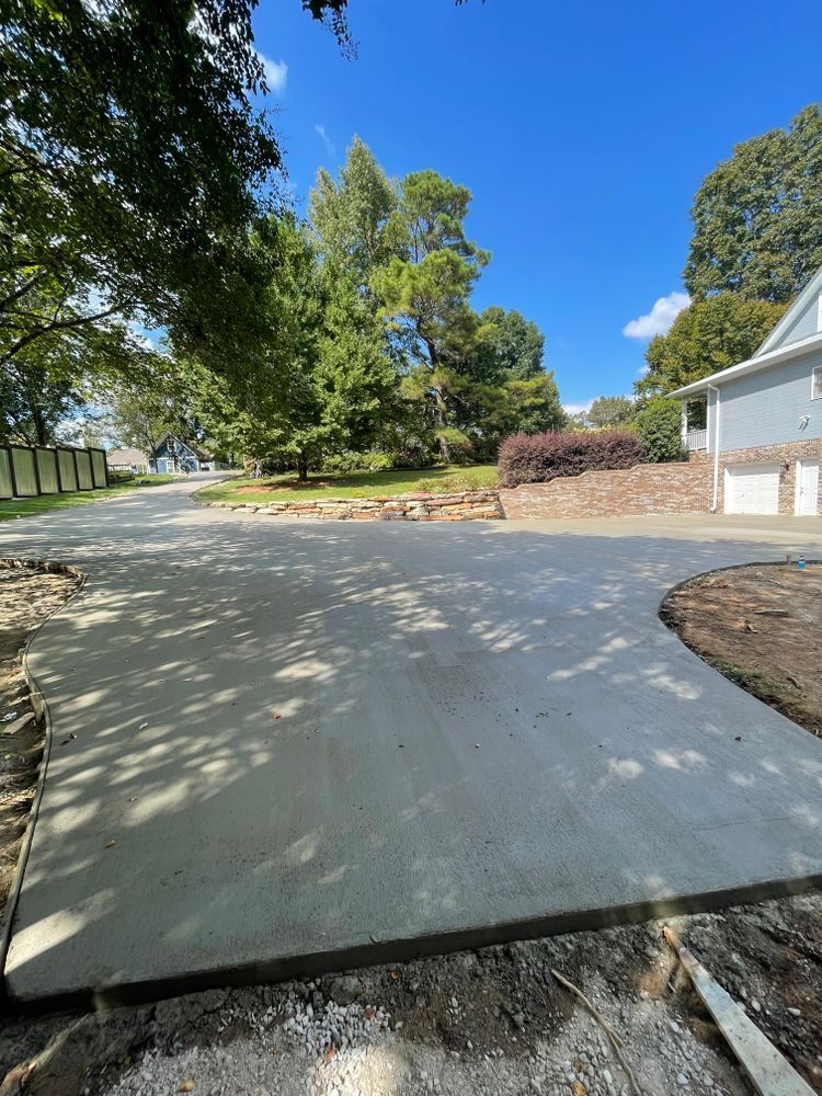 A concrete driveway is being built in front of a house.