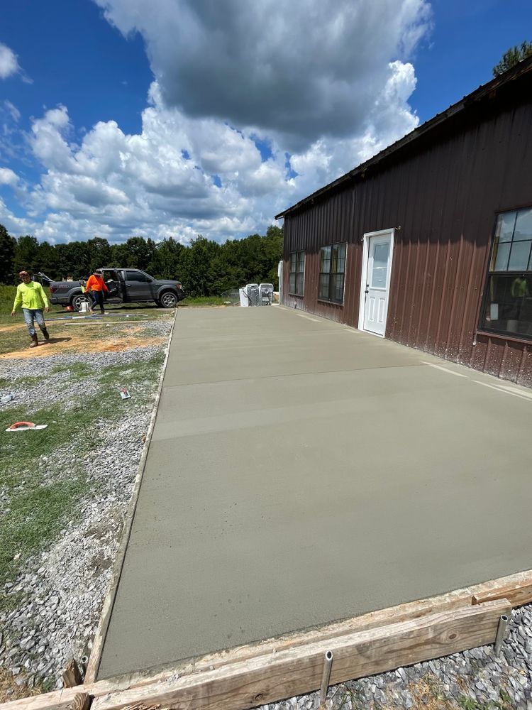 A concrete driveway is being built in front of a building.