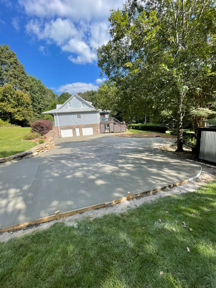 A concrete driveway is being built in front of a house.