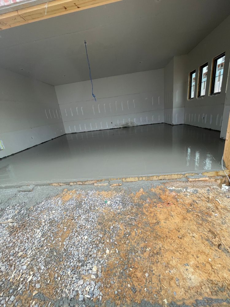 A large empty garage with a concrete floor.