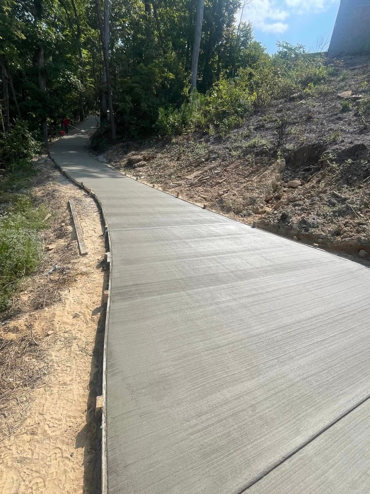 A concrete walkway is being built on top of a dirt hill.