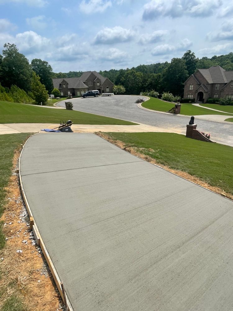 A concrete driveway is being built in a residential neighborhood.