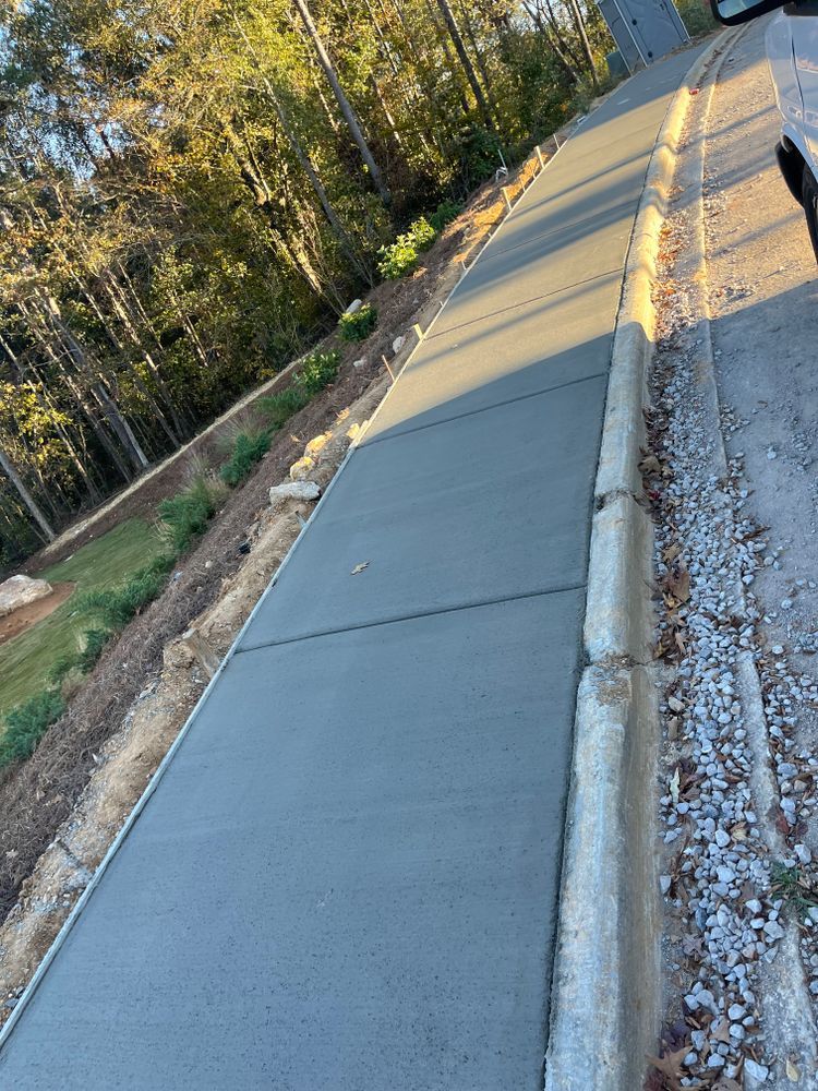 A concrete sidewalk is being built next to a road.