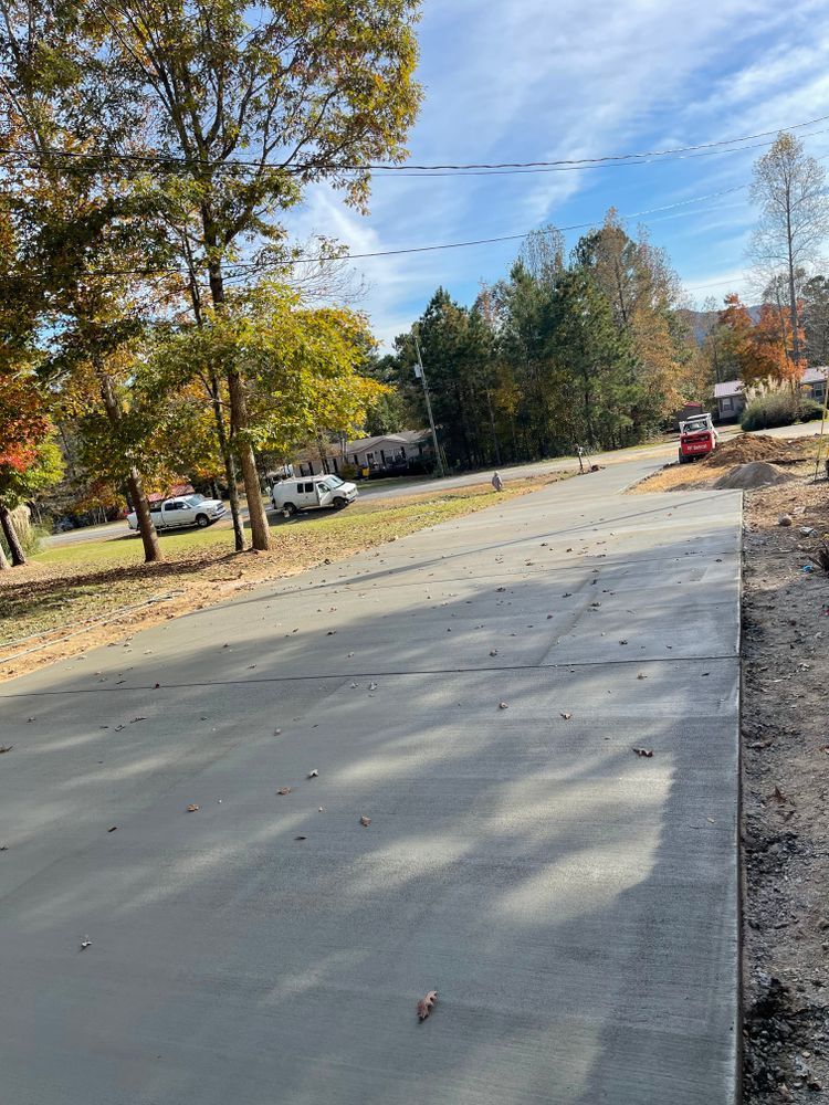 A concrete driveway is being built on the side of a road.