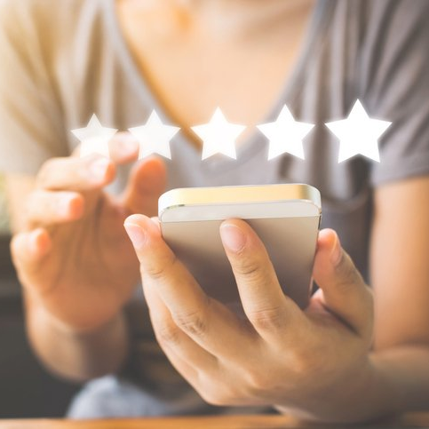 person rating 5 stars using mobile phone
