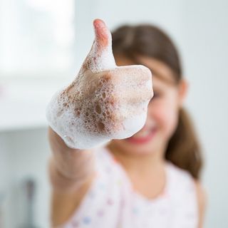 child's hand with bubbles on it, thumbs up