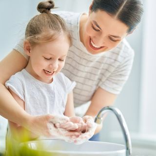 child and mother washing hands