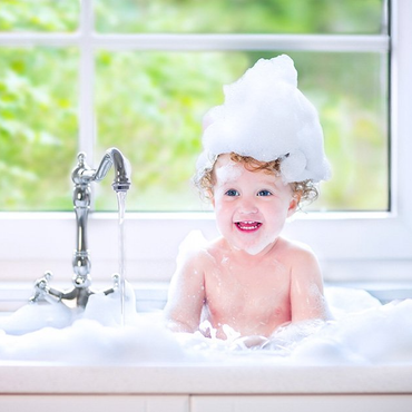 toddler taking a bubble bath