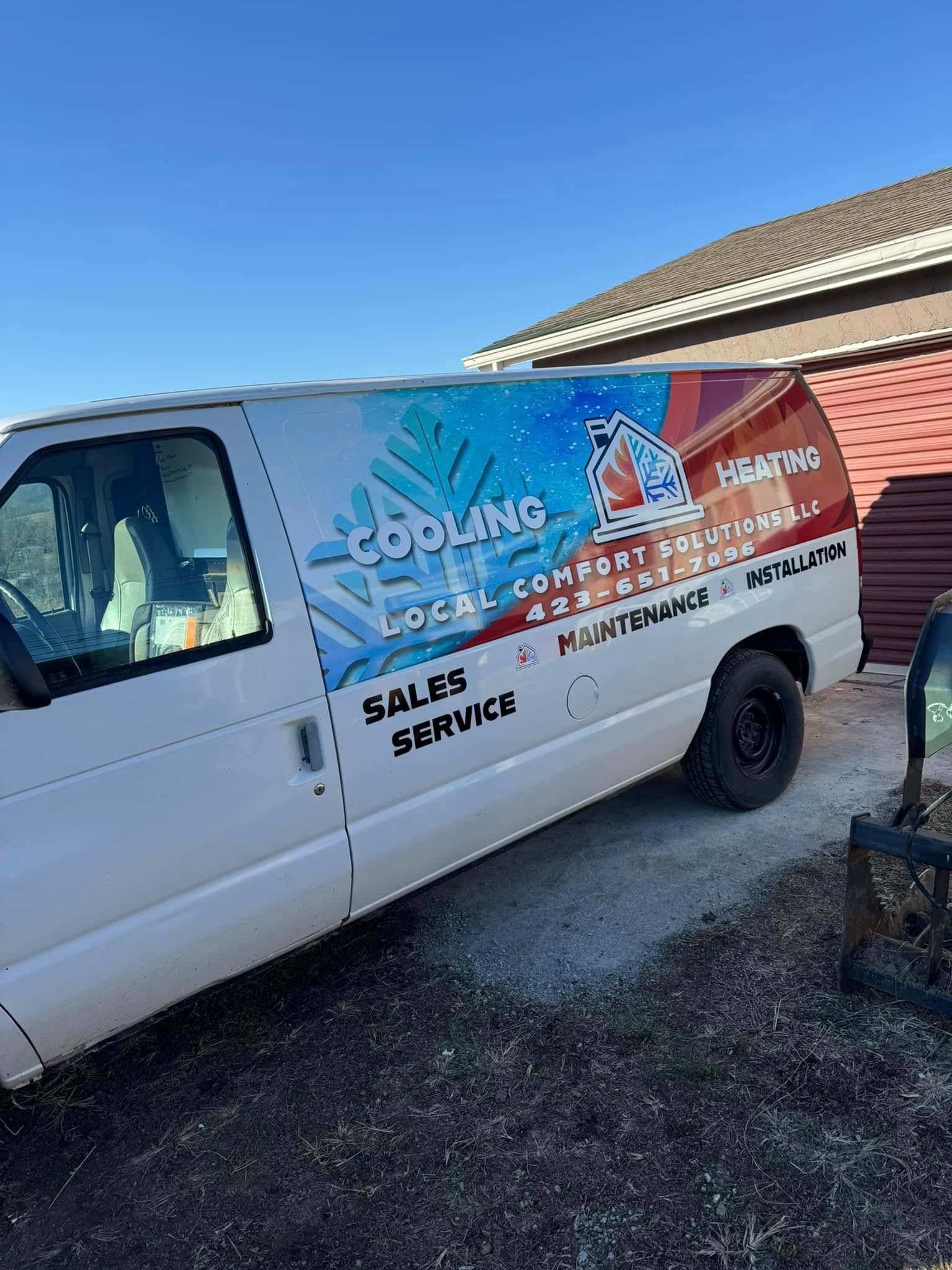 A white van is parked in front of a building.