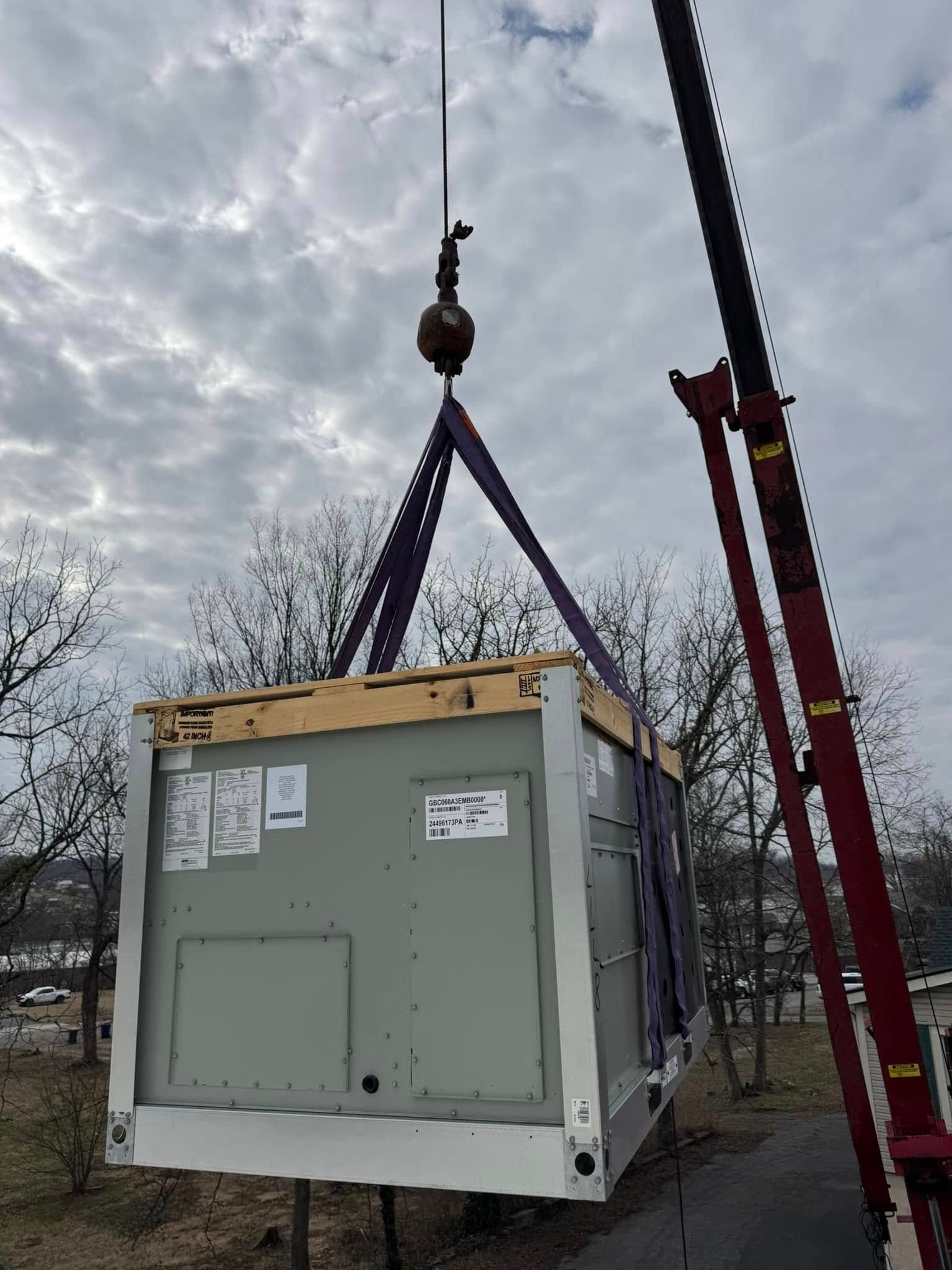 A large box is being lifted by a crane.