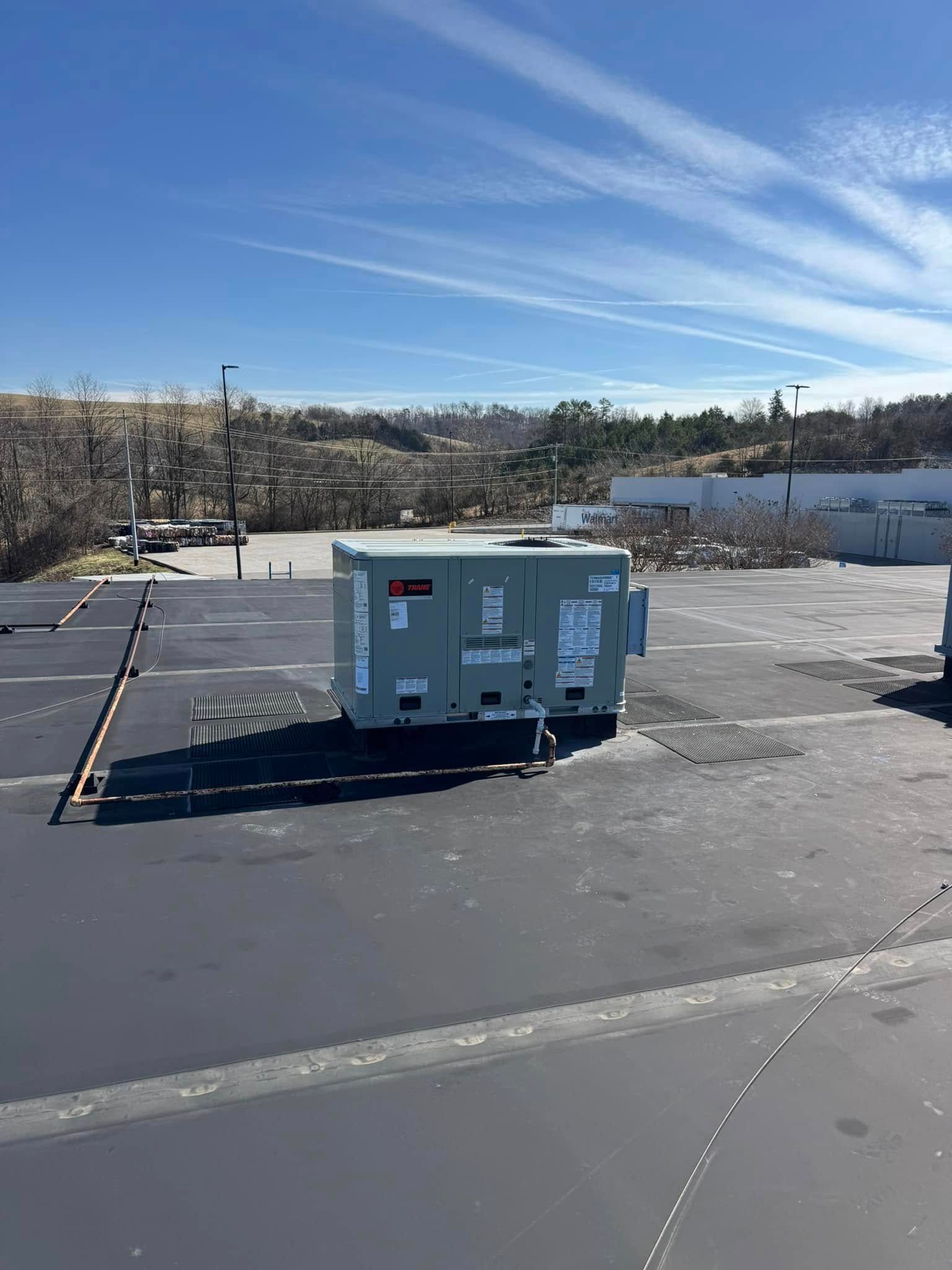 A large box is sitting in the middle of a parking lot.