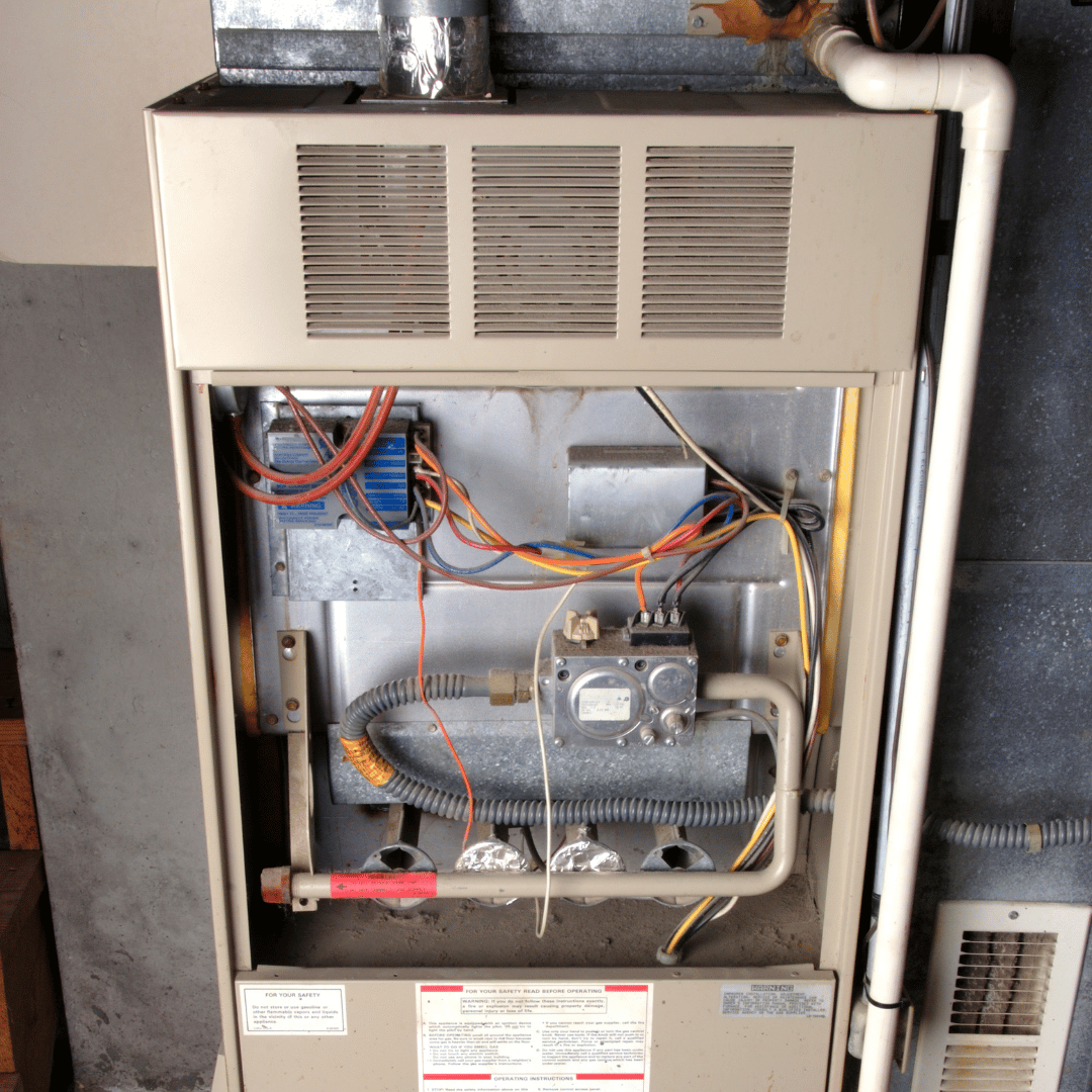 The inside of an air conditioner with a lot of wires coming out of it