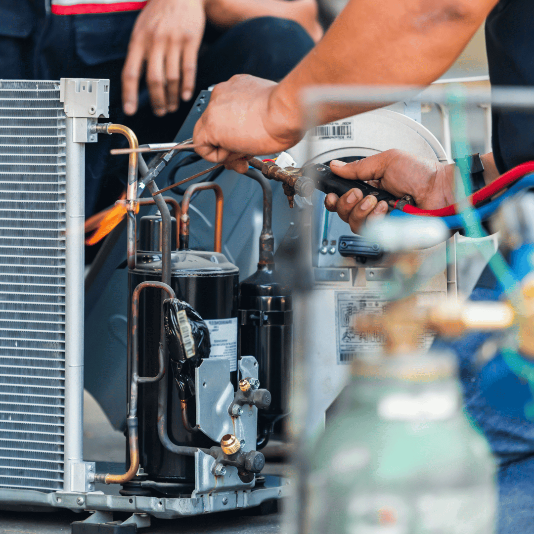 A man is working on an air conditioner.