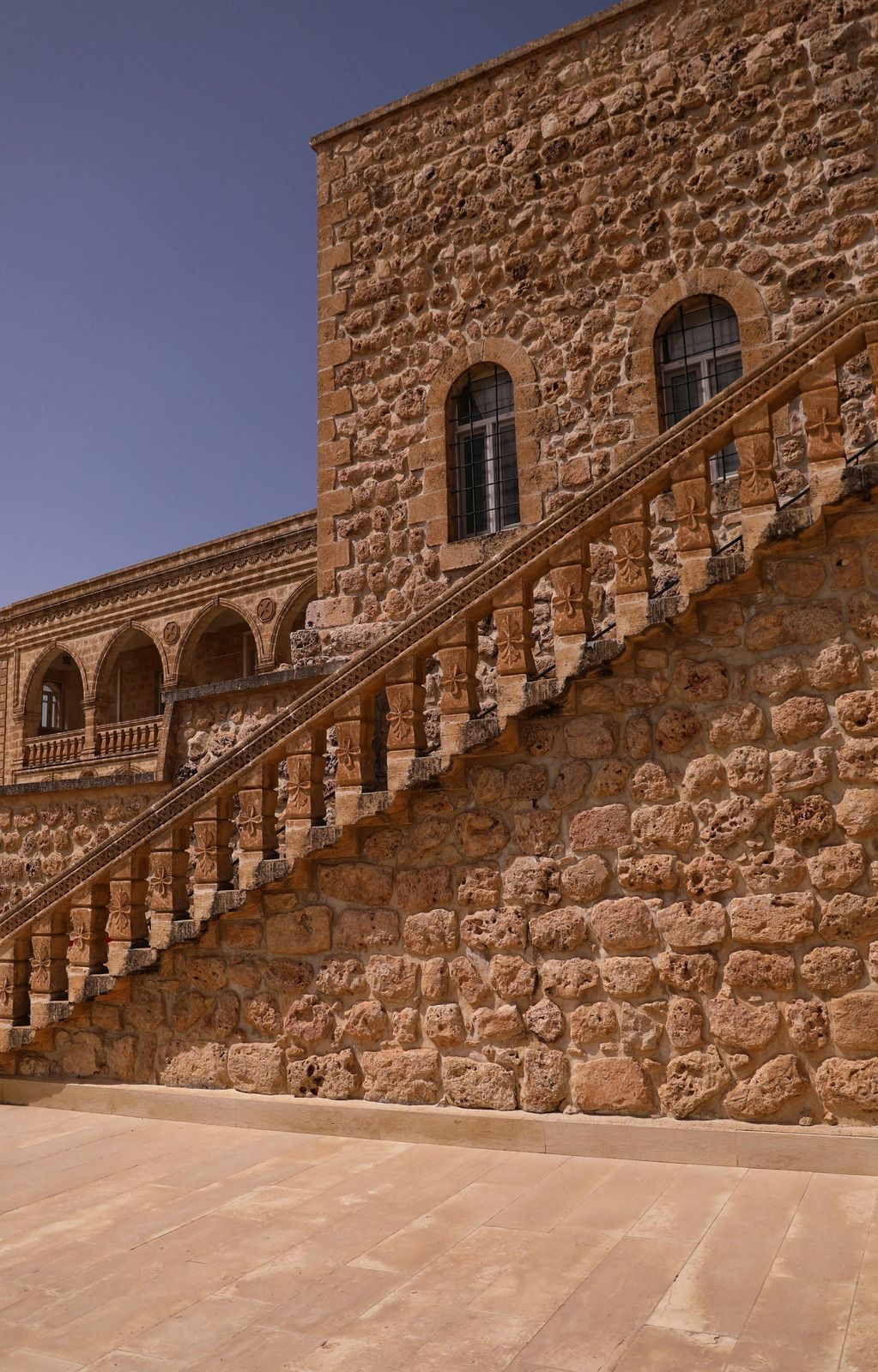 A stone building with stairs leading up to it.