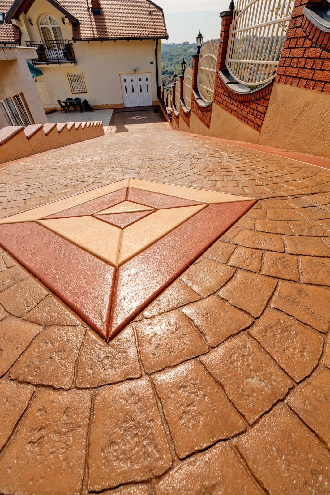 A brick walkway with a geometric design in the middle of it.