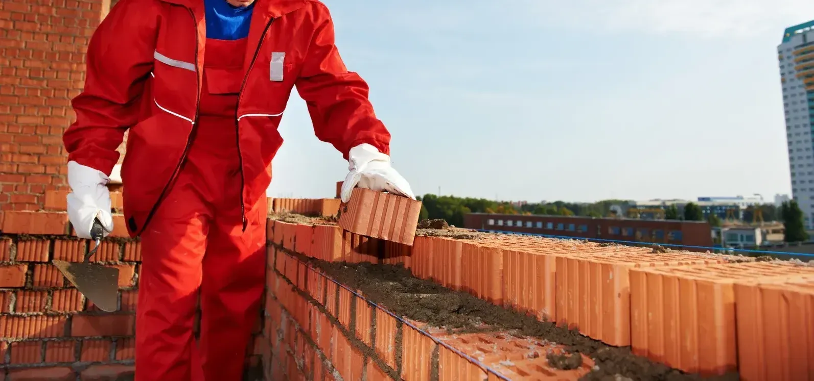 A brick wall is being built with white bricks