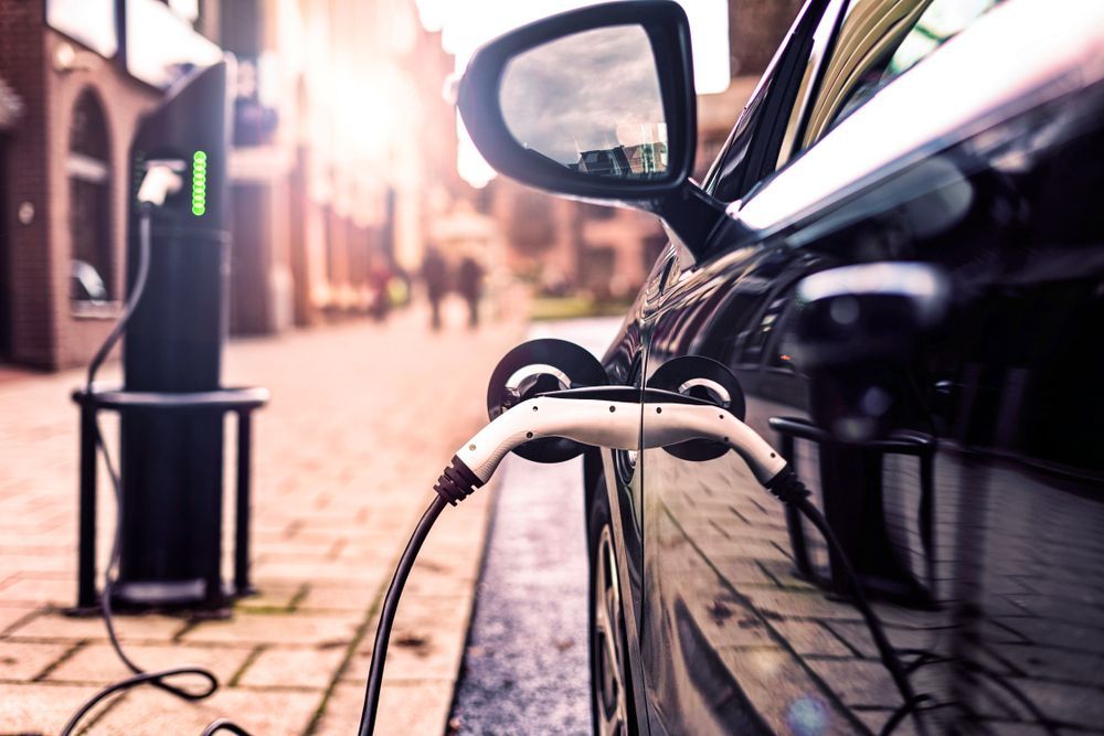 Electric Car Parked on the Street is Charging — EV Charger Installation in Wagga Wagga